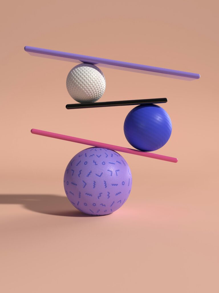 A group of three balls balancing on top of eachother, for “How to Balance Traditional and Alternative Assets When Starting your Investment Journey”