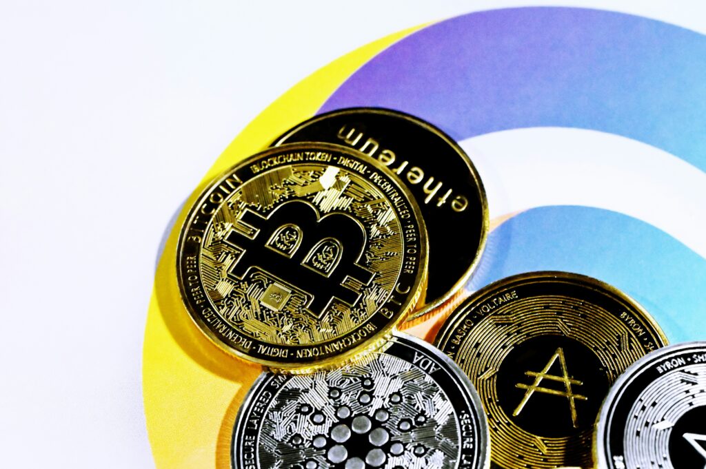 Several coins bearing different cryptocurrency logos, for “Are Tokenized Assets A Good Fit for Your Investment Portfolio?”