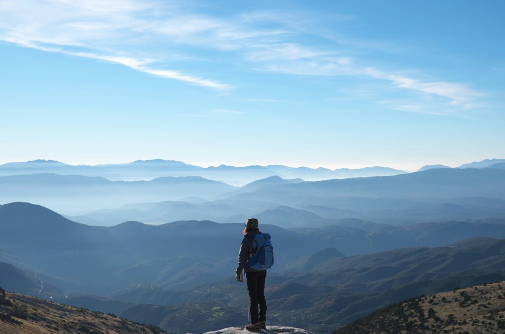 A hiker staring out at a gorgeous mountain landscape, for "Which Alternative Asset Should You Explore First? Quiz!"