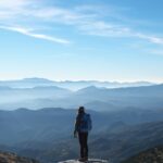 A hiker staring out at a gorgeous mountain landscape, for "Which Alternative Asset Should You Explore First? Quiz!"